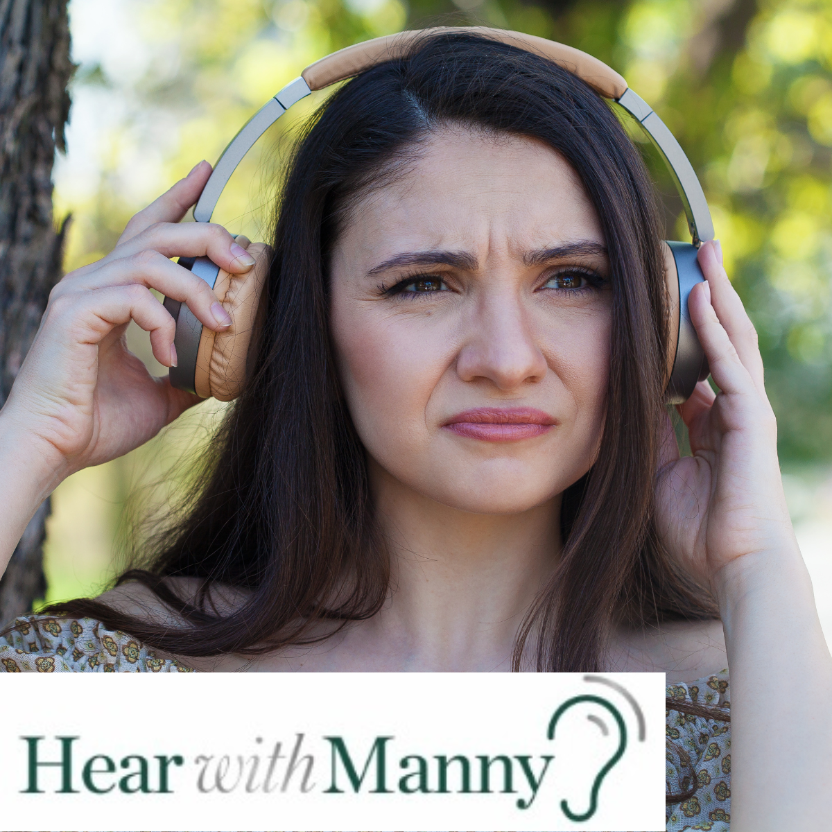 Woman looking concerned taking her headphones off.